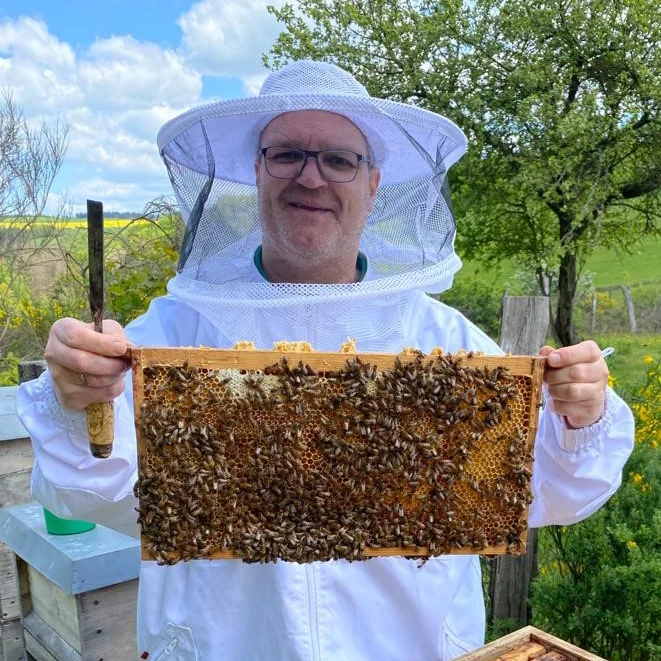 Picture Markus Gessner as a beekeeper harvesting honey